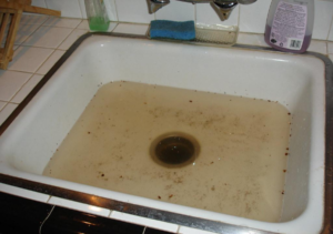 The common sign of a clogged kitchen sink is the water doesn't drain