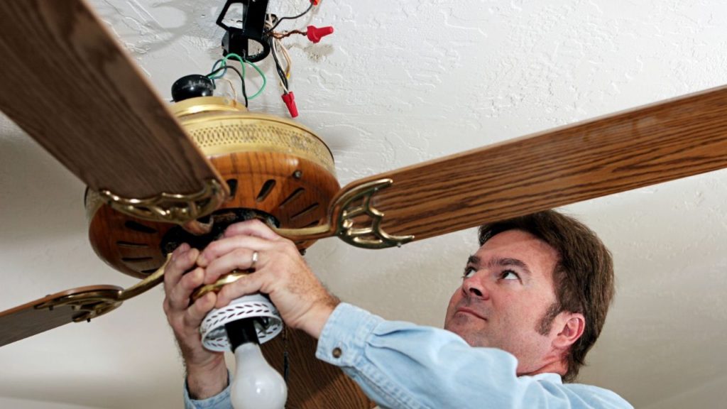 Man removing old ceiling fan