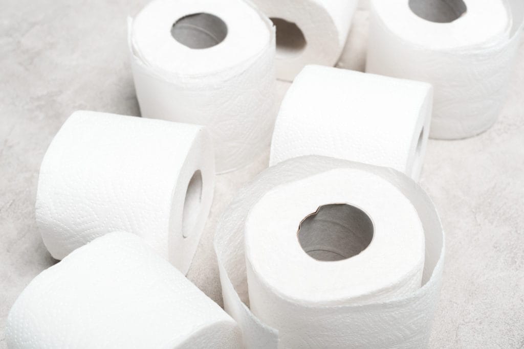 Close Up View Of Rolls Of Toilet Paper On Grey Textured Surface Stockpack Deposit Photos