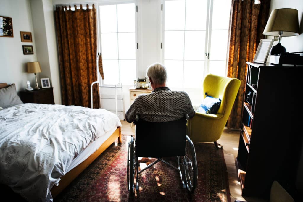 Senior,man,sitting,on,the,wheelchair,alone