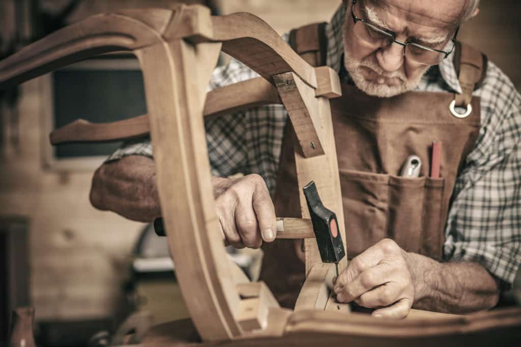Elderly,carpenter,builds,a,classic,style,chair