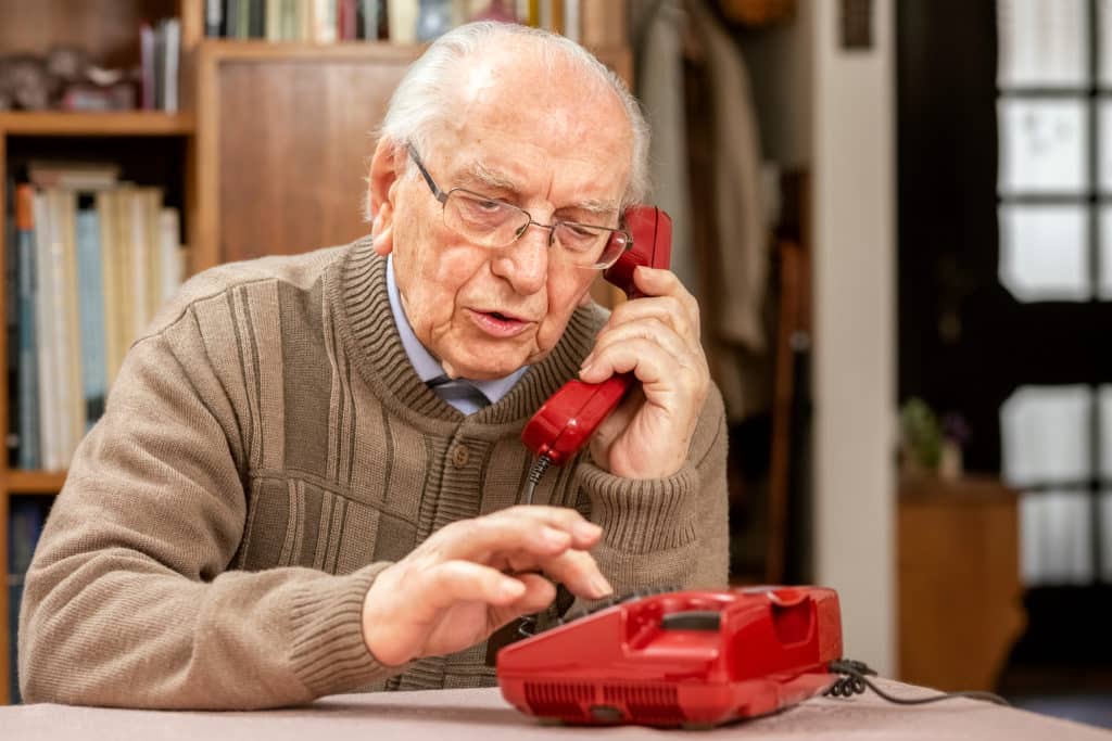 Grandfather,with,old,red,button,telephone