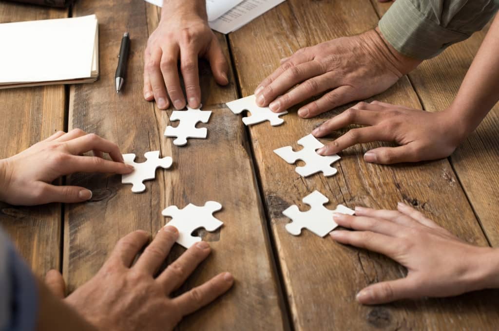 Closeup,of,businessman,and,woman,with,jigsaw,puzzle,pieces,in