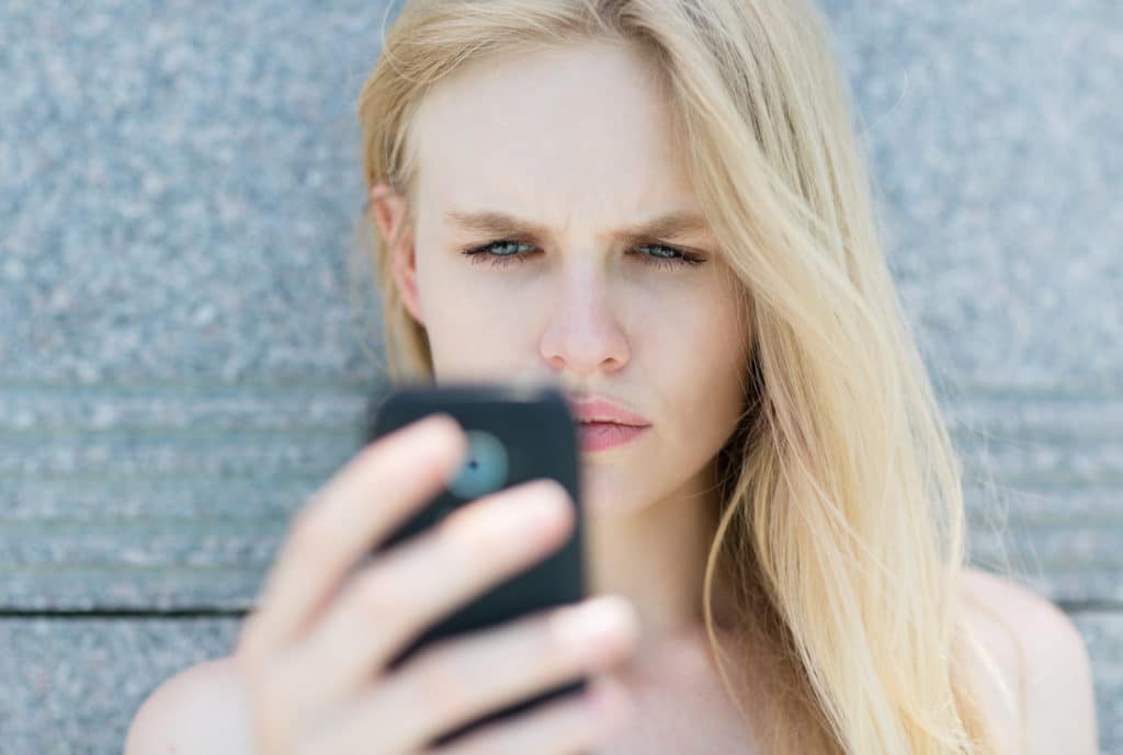 Upset woman holding a cellphone