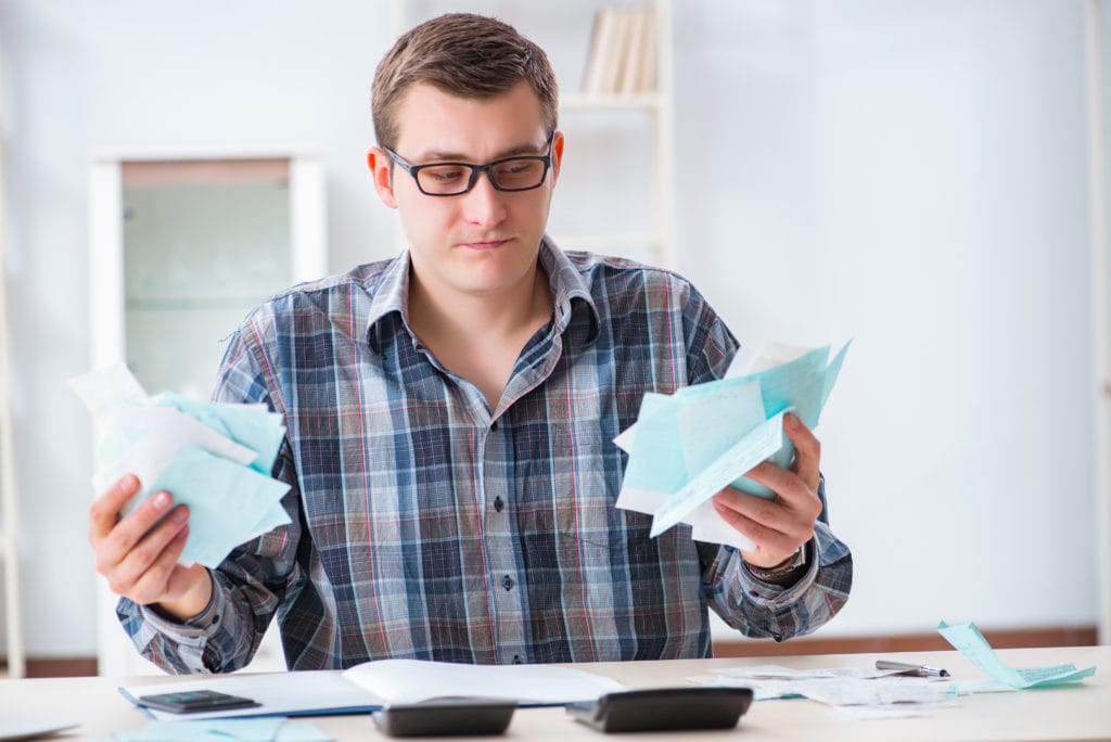 Young man frustrated at his house and tax bills