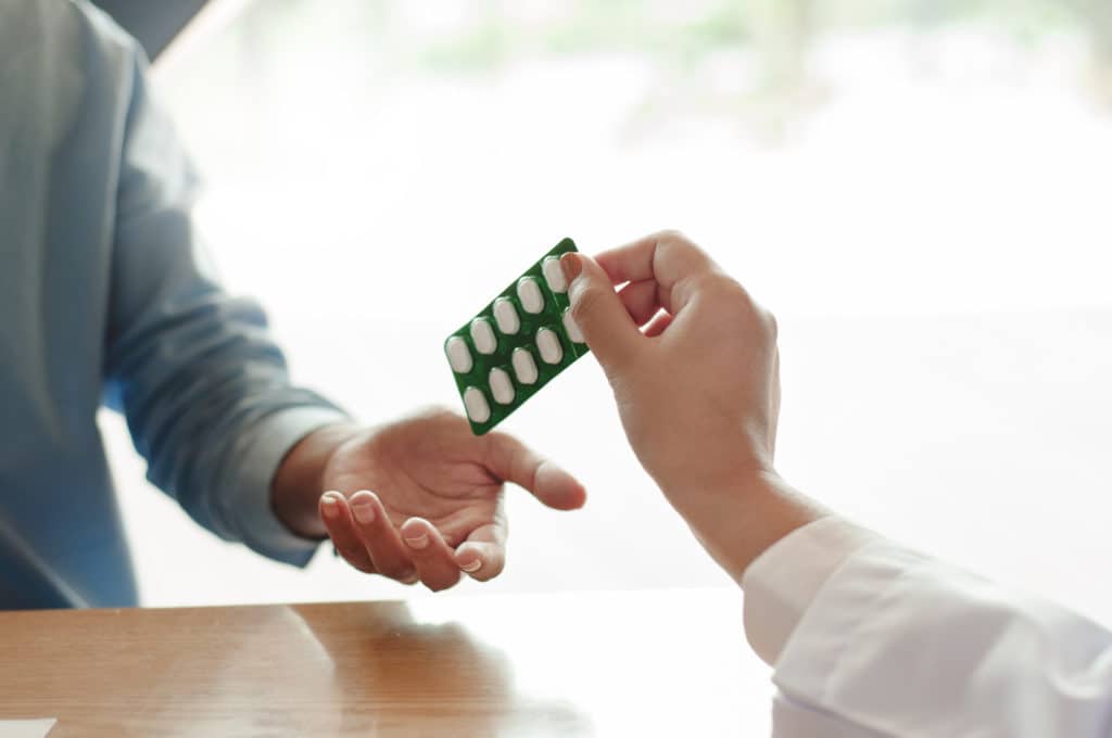 Medicine Doctor Giving A Blister Of Pill To Patient