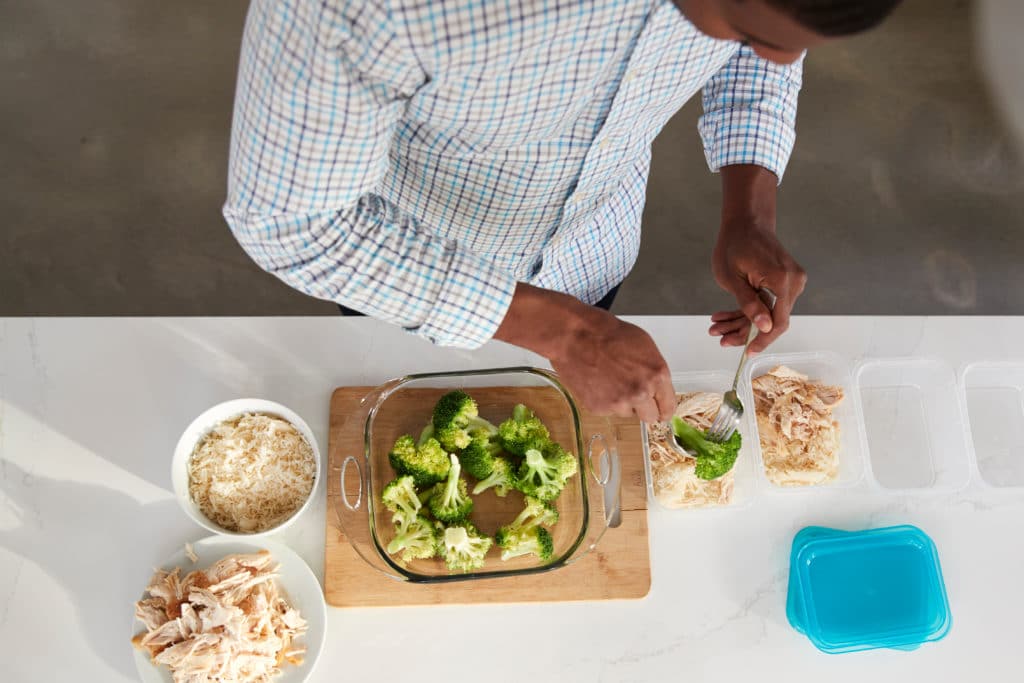 Overhead View Of Man In Kitchen Preparing High Protein Meal