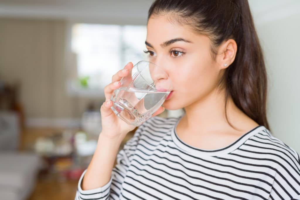Beautiful Young Woman Drinking A Fresh Glass Of Water At