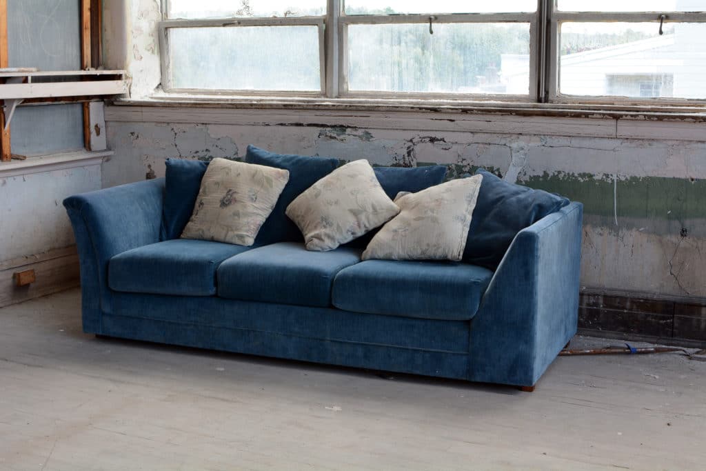 Blue Couch In Room Of An Abandoned Building