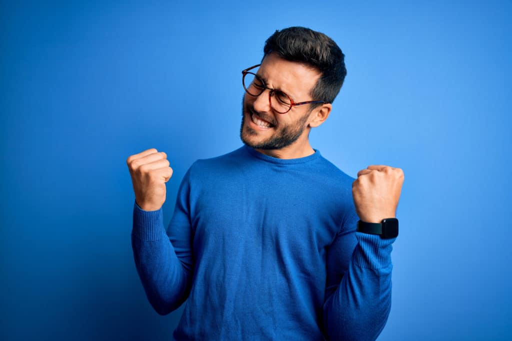 Young Handsome Man With Beard Wearing Casual Sweater And Glasses