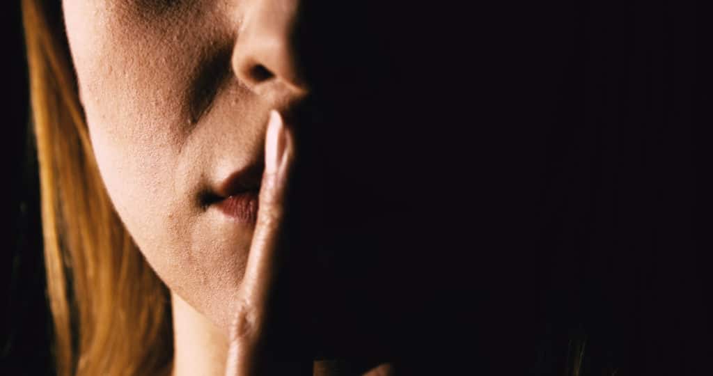 Seriouse Woman Placing Her Finger On Lips Keep Silence