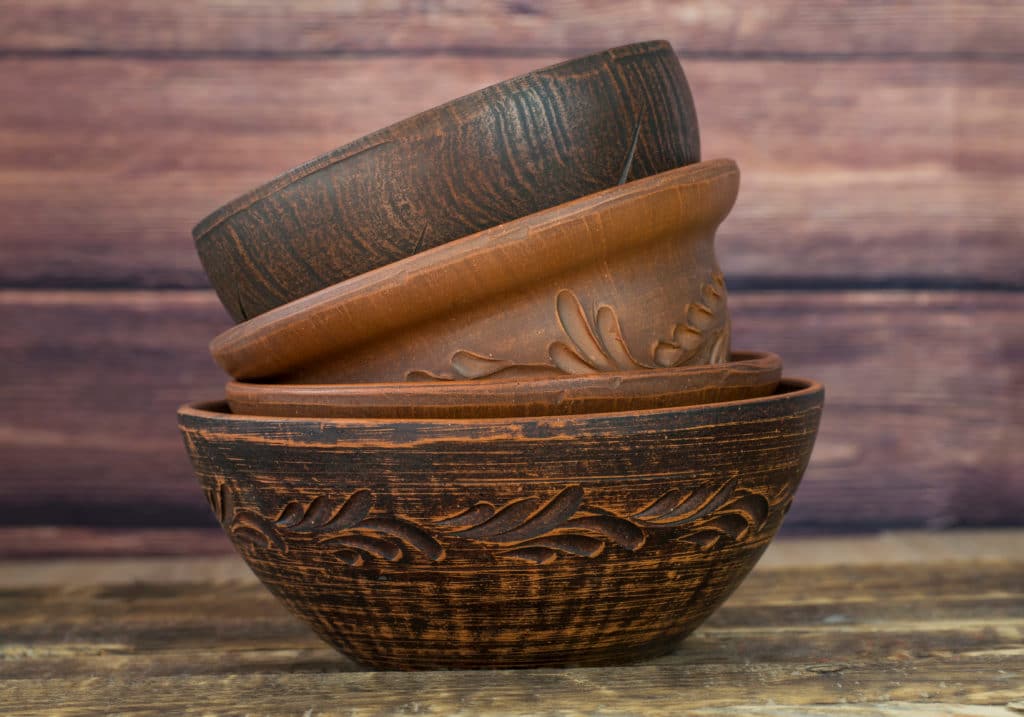 Various Clay Bowls Stacked One Into Another On A Wooden