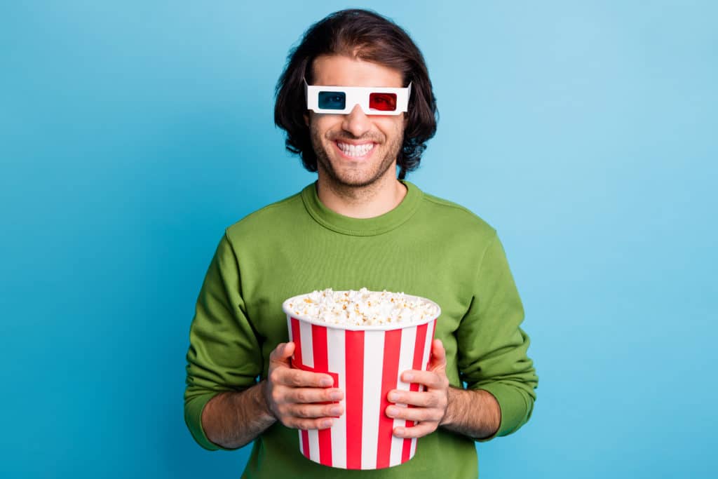 Photo Of Cheerful Guy Hold Popcorn Paper Box Toothy Smile