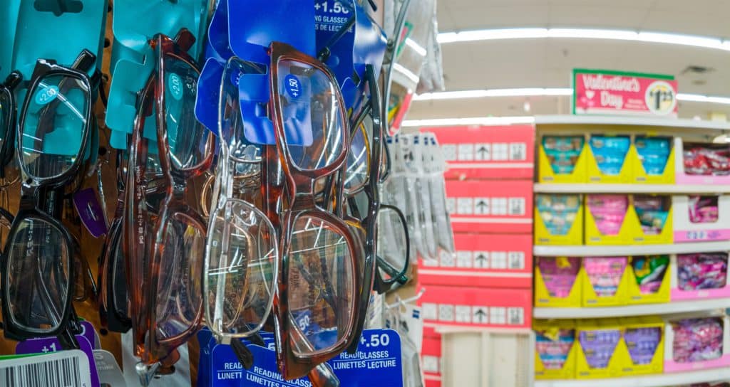 Many Reading Glasses On A Rack Stand Inside The Dollar