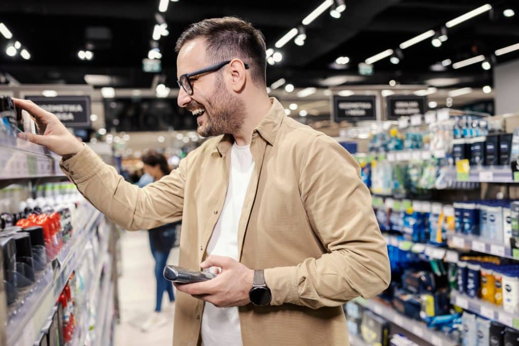 A Happy Guy Picking Deodorant At Hypermarket.