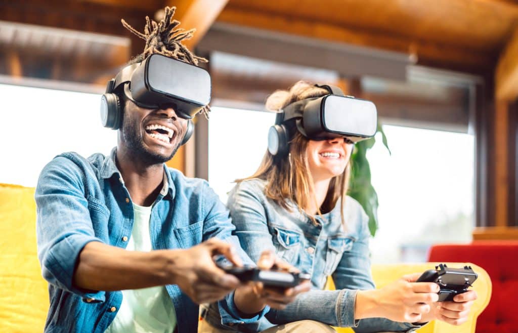 Millenial Couple Playing With Vr Glasses At Home Couch 