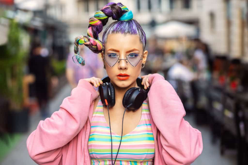 Cool Funky Young Woman With Trendy Eyeglasses Listening Music On