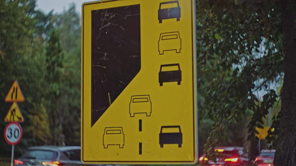 Zipper Merging Lane Road Caution Sign Standing By Busy Street