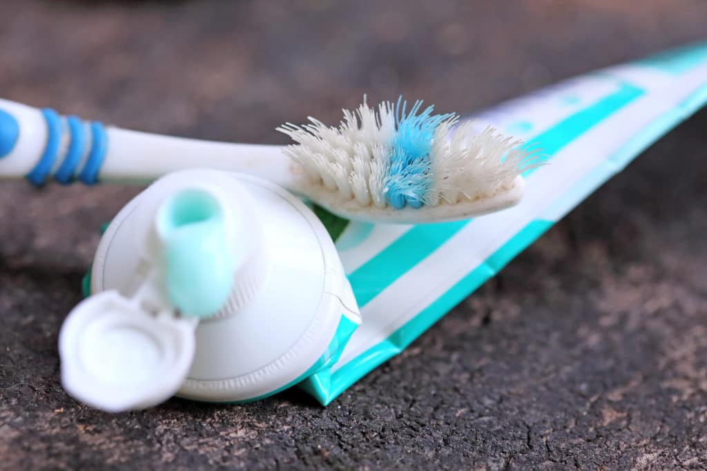 Still Life With Old Toothbrush And Toothpaste Tubes