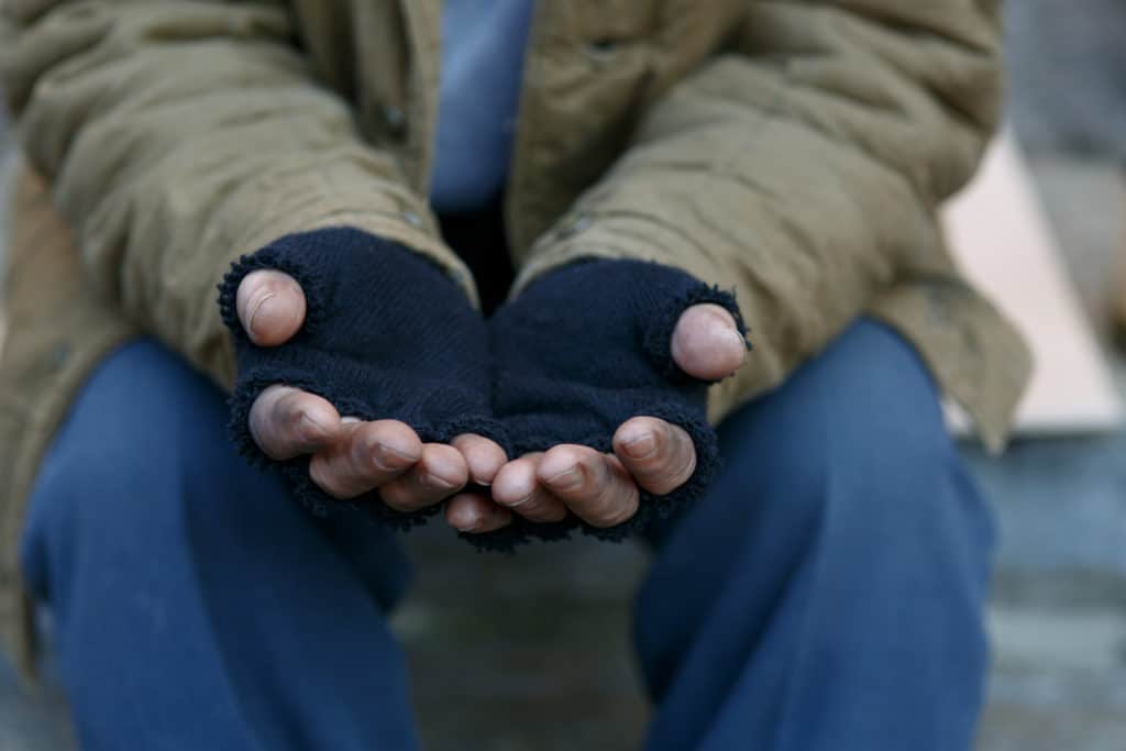 Man In Need. Unhappy Homeless Man Is Holding Hands To