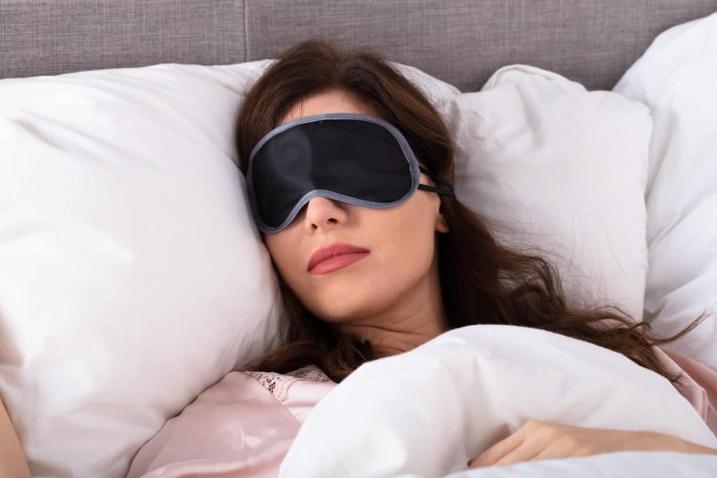 Close Up Of Beautiful Young Woman Sleeping On Bed With Eye