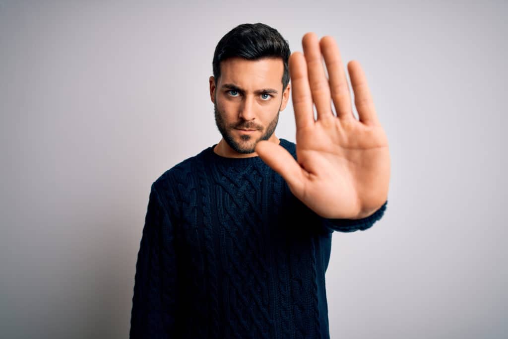 Young Handsome Man With Beard Wearing Casual Sweater Standing Over