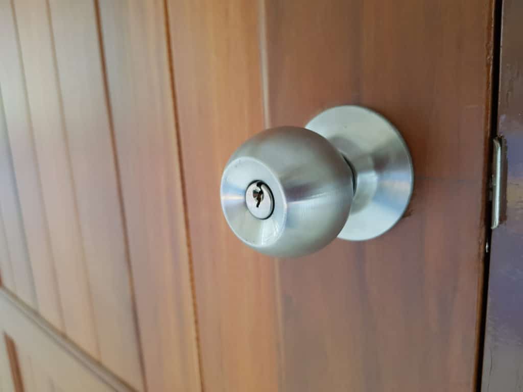 A Round Door Knob Installed On A Wooden Door
