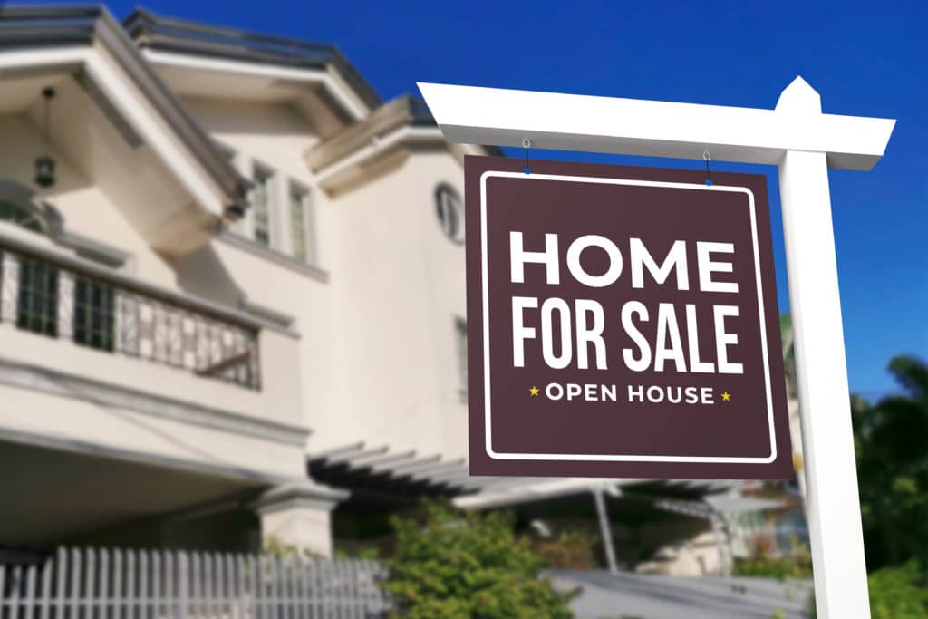 A Home For Sale And Open House Sign In Front