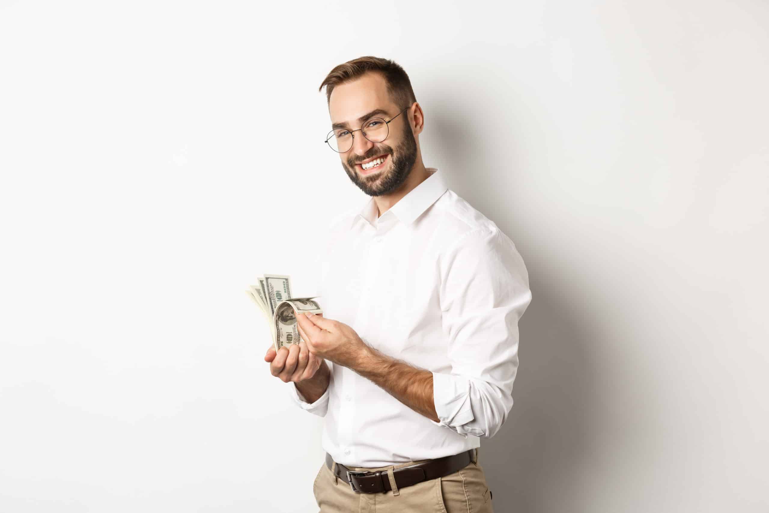 Successful Business Man Counting Money And Smiling Standing Against White