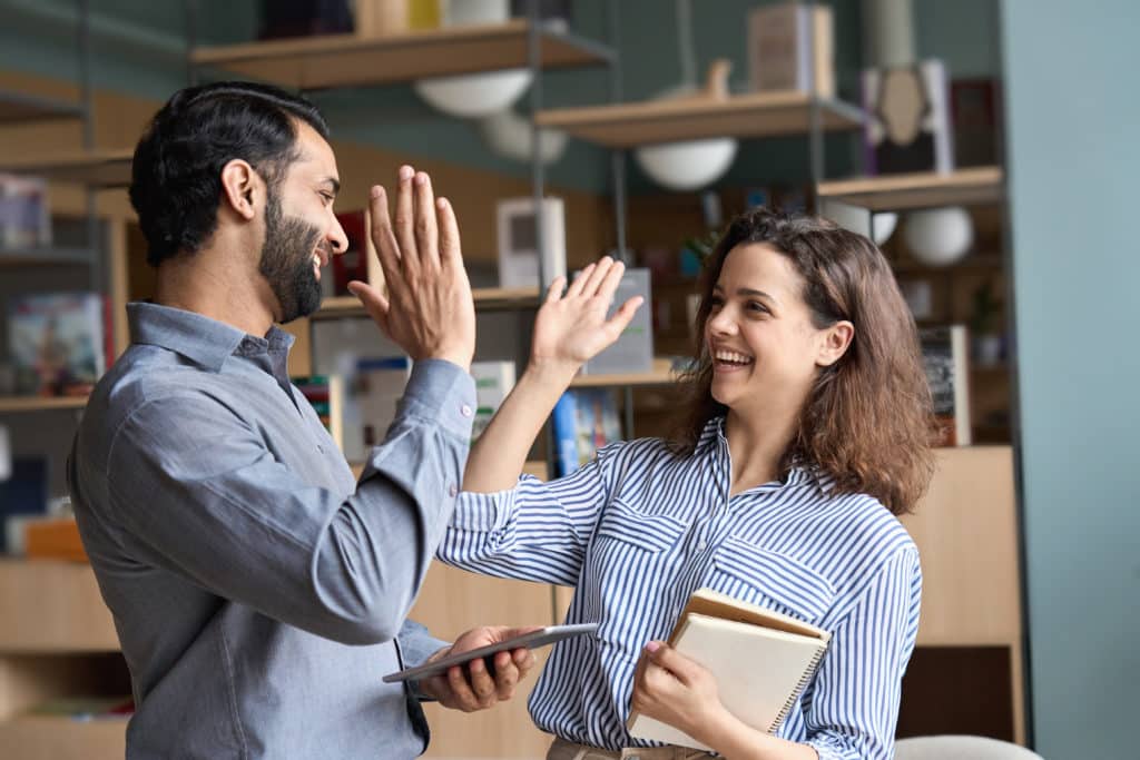 Two Happy Friendly Diverse Professionals Teacher And Student Giving High