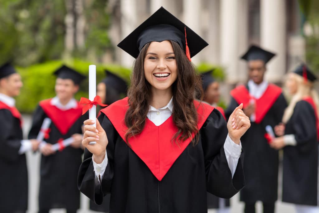 Emotional Young Woman Student Having Graduation Party Wearing Graduation Robe