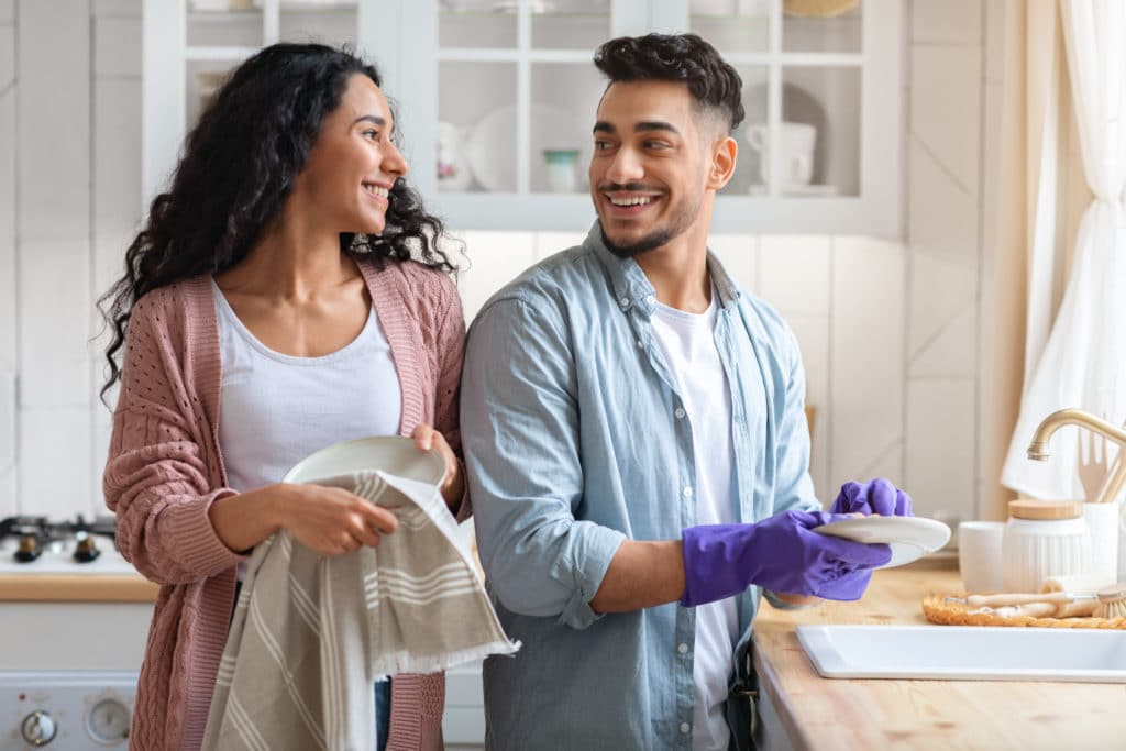 Cheerful Middle Eastern Couple Sharing Domestic Chores Washing Dishes Together