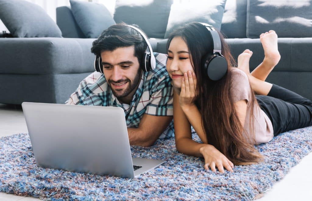 Young Couple Laying On Floor Listen Music With Headphone And