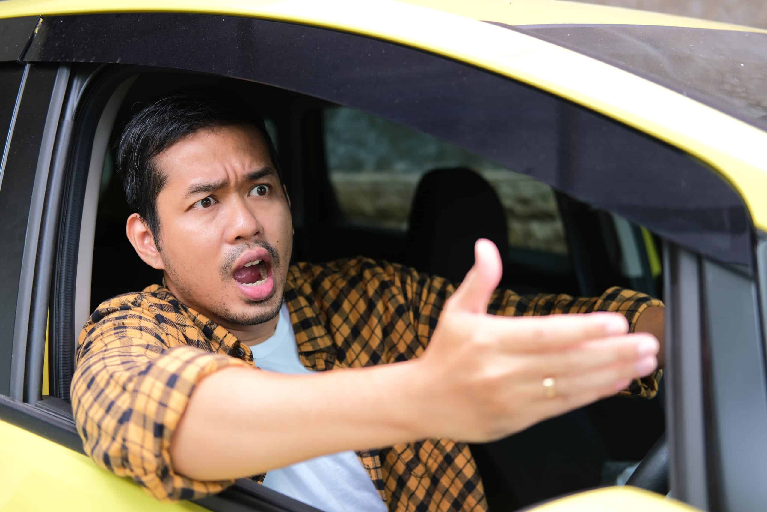 Adult Asian Man Showing Furious Expression While Driving A Car