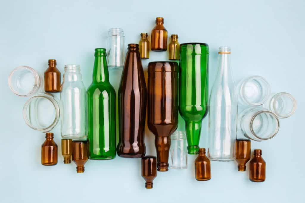 Separate Collection Of Glass Garbage. Colorful Bottles And Cans For