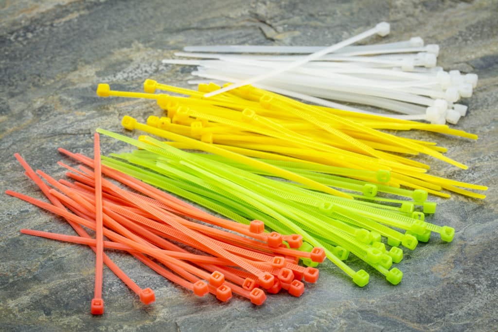 Self Locked Plastic Zip Cable Ties In Different Colors Over Slate
