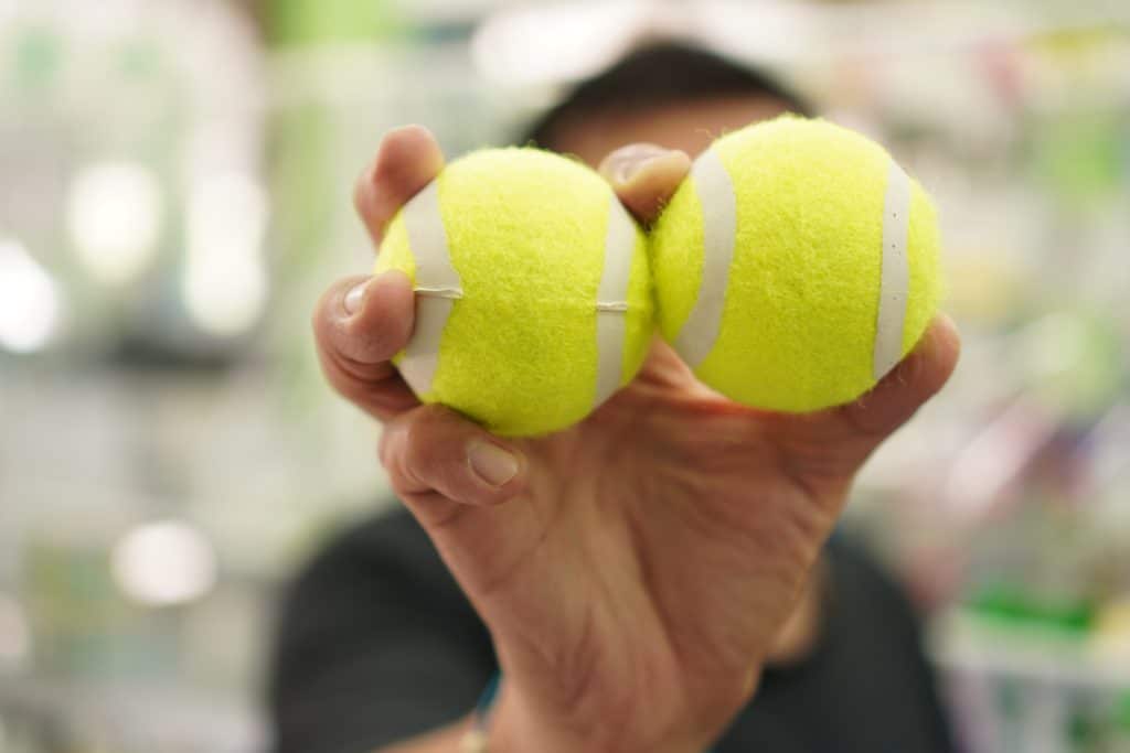 Tennis: Image Showing A Two Tennis Balls In Hand Close Up 