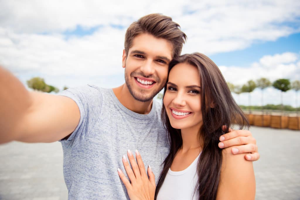 Loving Cheerful Happy Couple Taking Selfie In The City