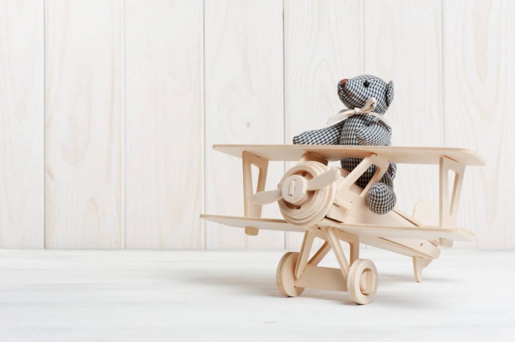 Cute Teddy Bear On Wooden Background With Wooden Baby Toys