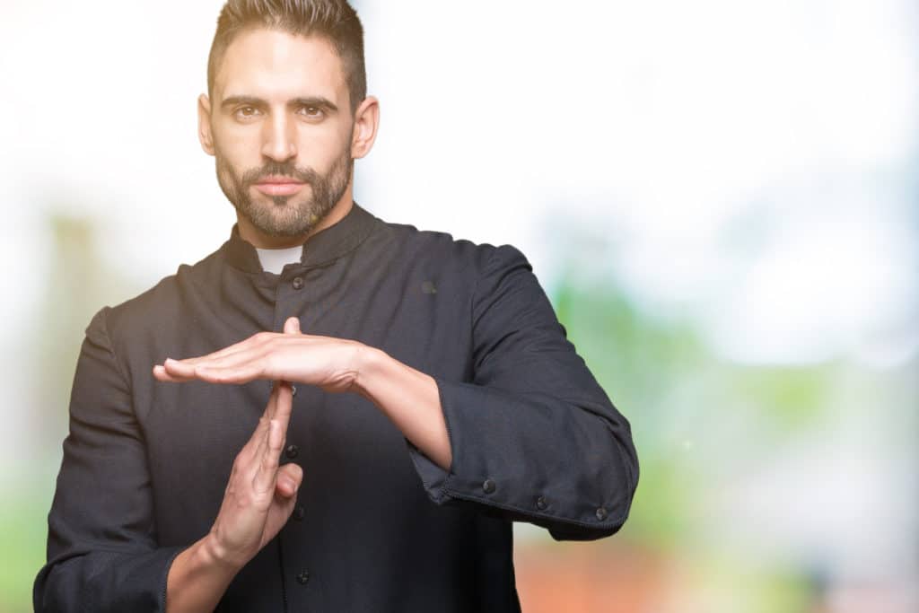Young Christian Priest Over Isolated Background Doing Time Out Gesture With Hands Frustrated And Serious Face