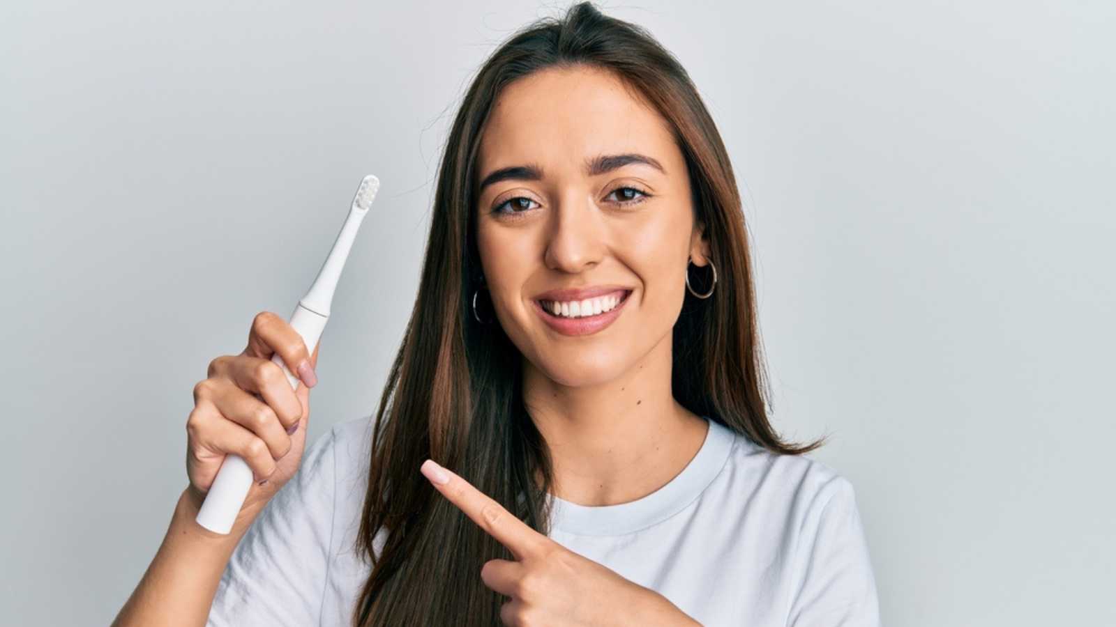 Woman using Electric Toothbrush