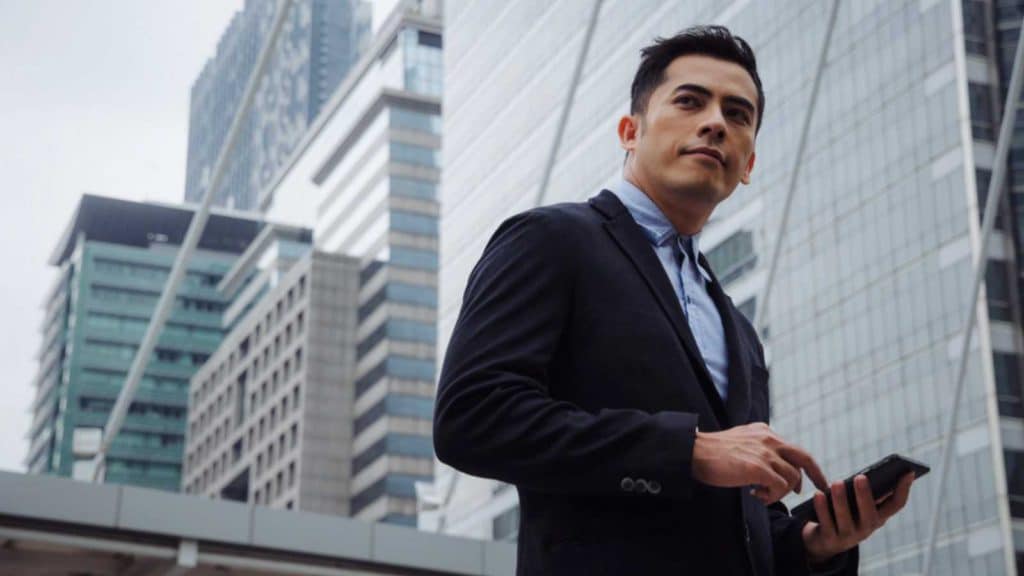 young handsome asian business man wearing modern black suit