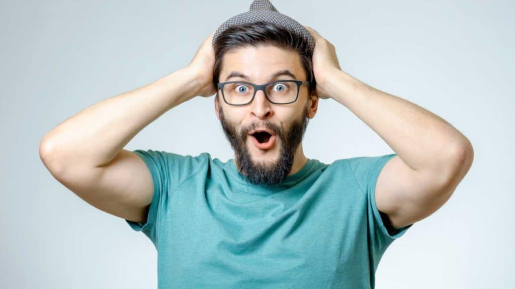 Shocked Man With Hands On Head giving unbelievable expression