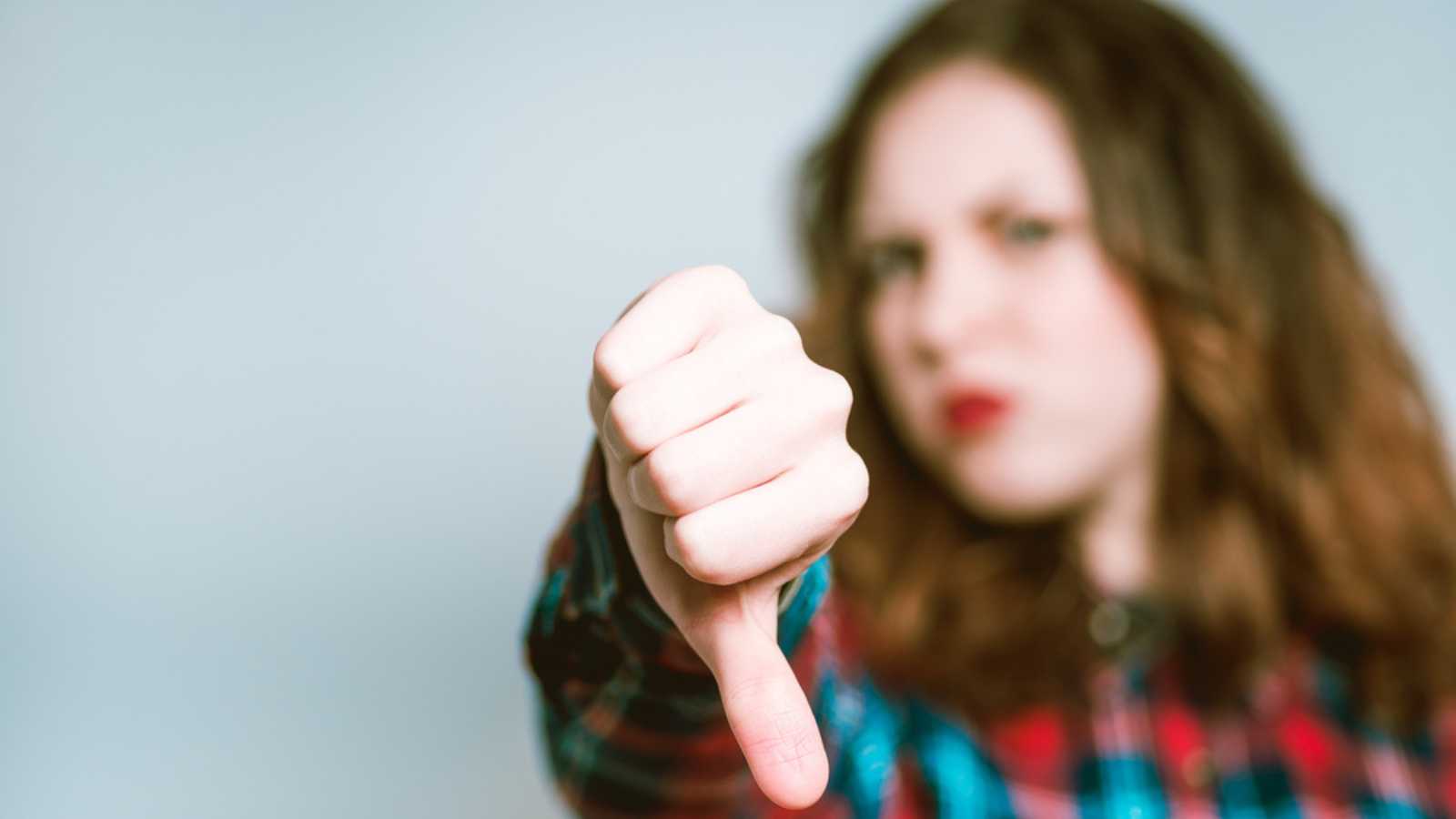 Woman Showing Thumbs Down Hating Someone