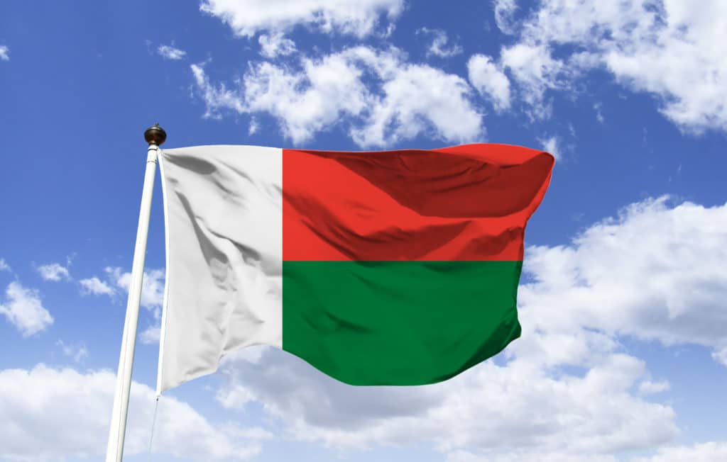 Mockup Of Madagascar Flag Floating Under Blue Sky. A Large