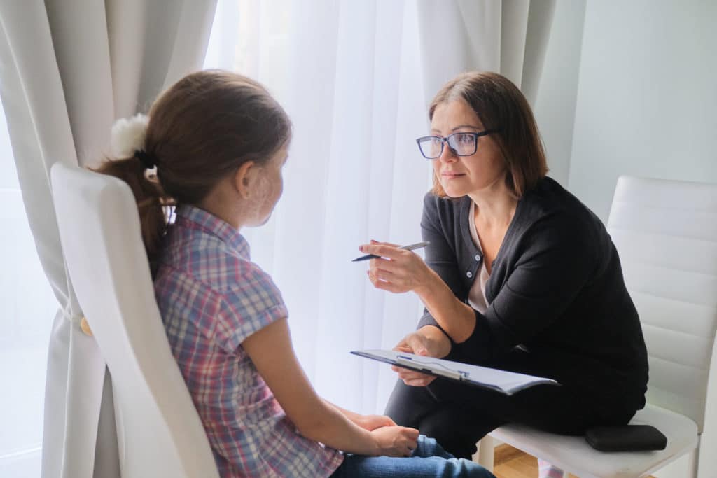 Woman Social Worker Talking To Girl. Child Psychology Mental Health.