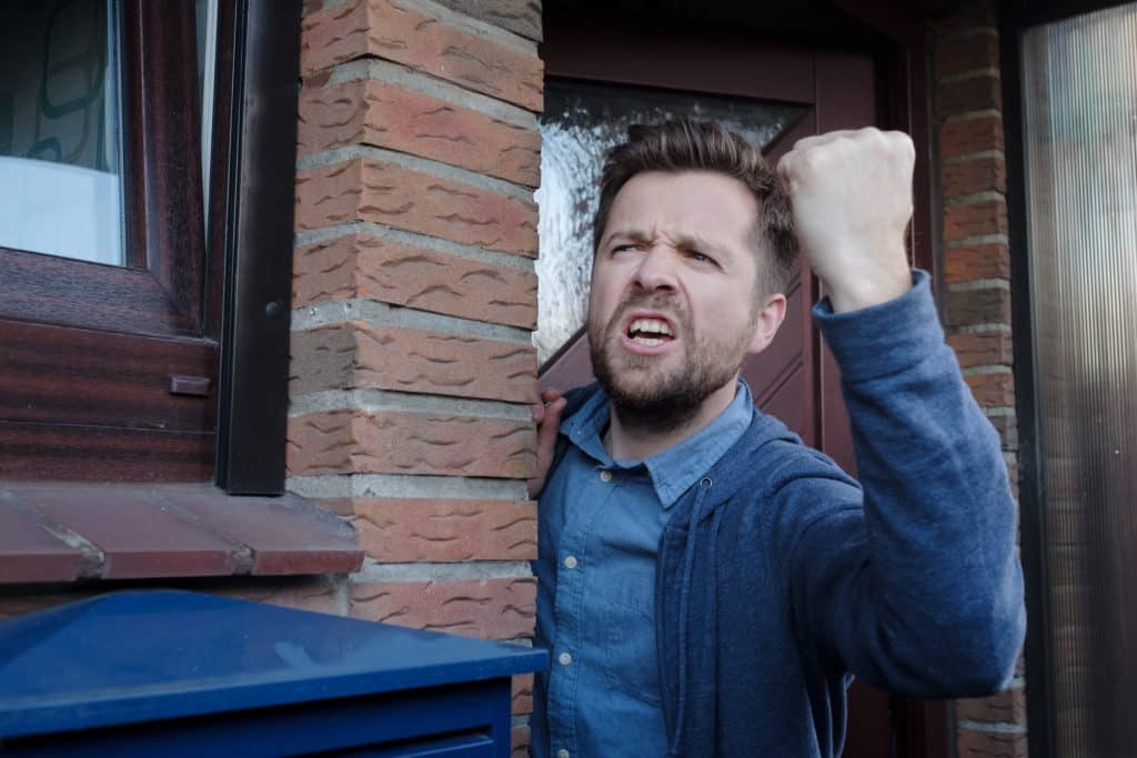 Angry Upset Young Male Neighbor With Fist In Air Open