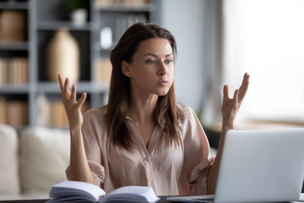 Unhappy Young Woman Looking At Laptop Screen Irritated By Bad