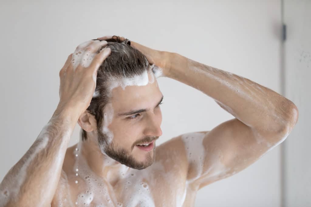 Close Up Of Young Naked Caucasian Man Wash Clean Hair