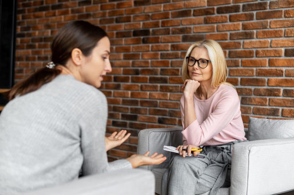 Worried Young Woman Patient Sitting At A Psychologist's Therapist Appointment